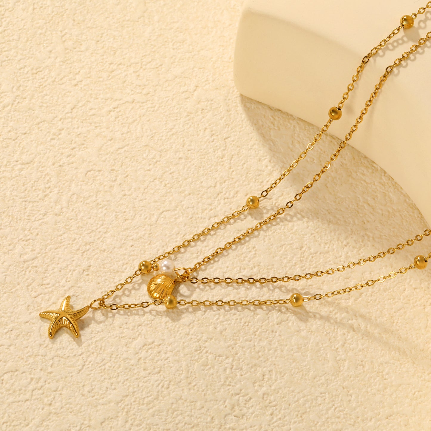 COLLAR DOBLE MINI ESTRELLA PERLA